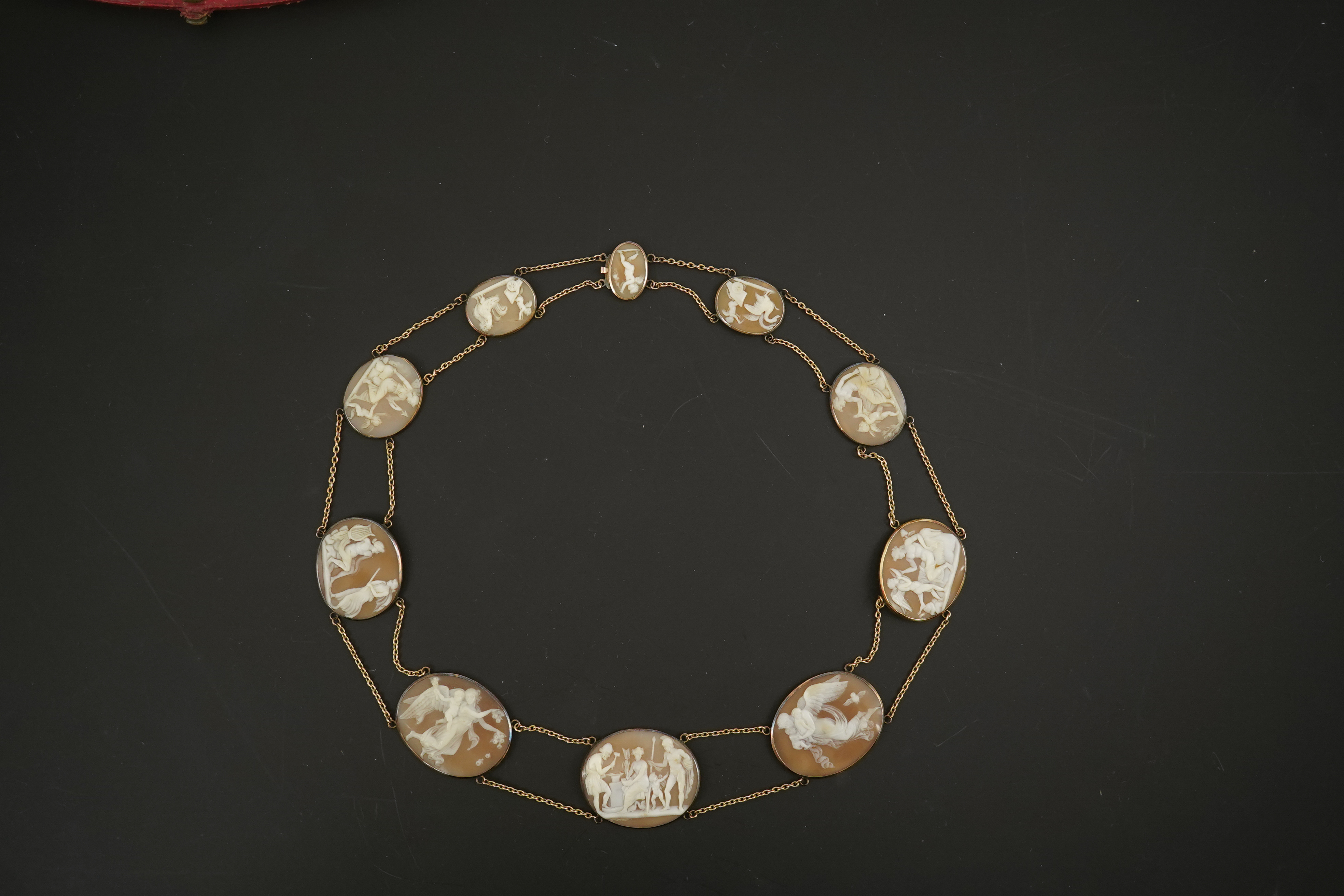 An early 19th century Italian Grand Tour gold double chain link and ten graduated oval cameo shell set necklace